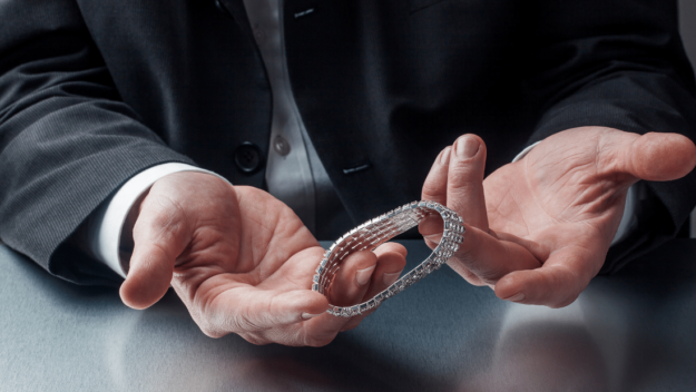 Closeup of Gentleman’s hands holding silver bracelet Closeup of Gentleman's hands holding silver bracelet