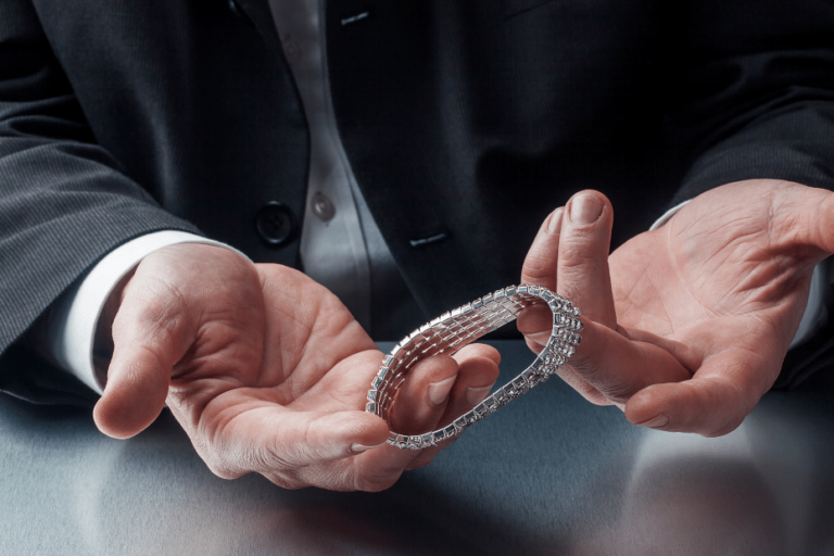 Closeup of Gentleman’s hands holding silver bracelet Closeup of Gentleman's hands holding silver bracelet
